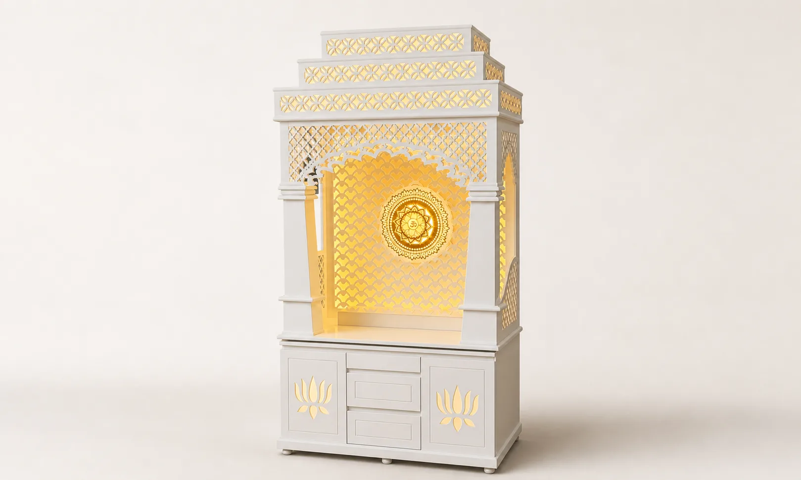White tiered mandir unit with amber-lit fish-scale lattice arch and carved lotus motifs on the base doors.
